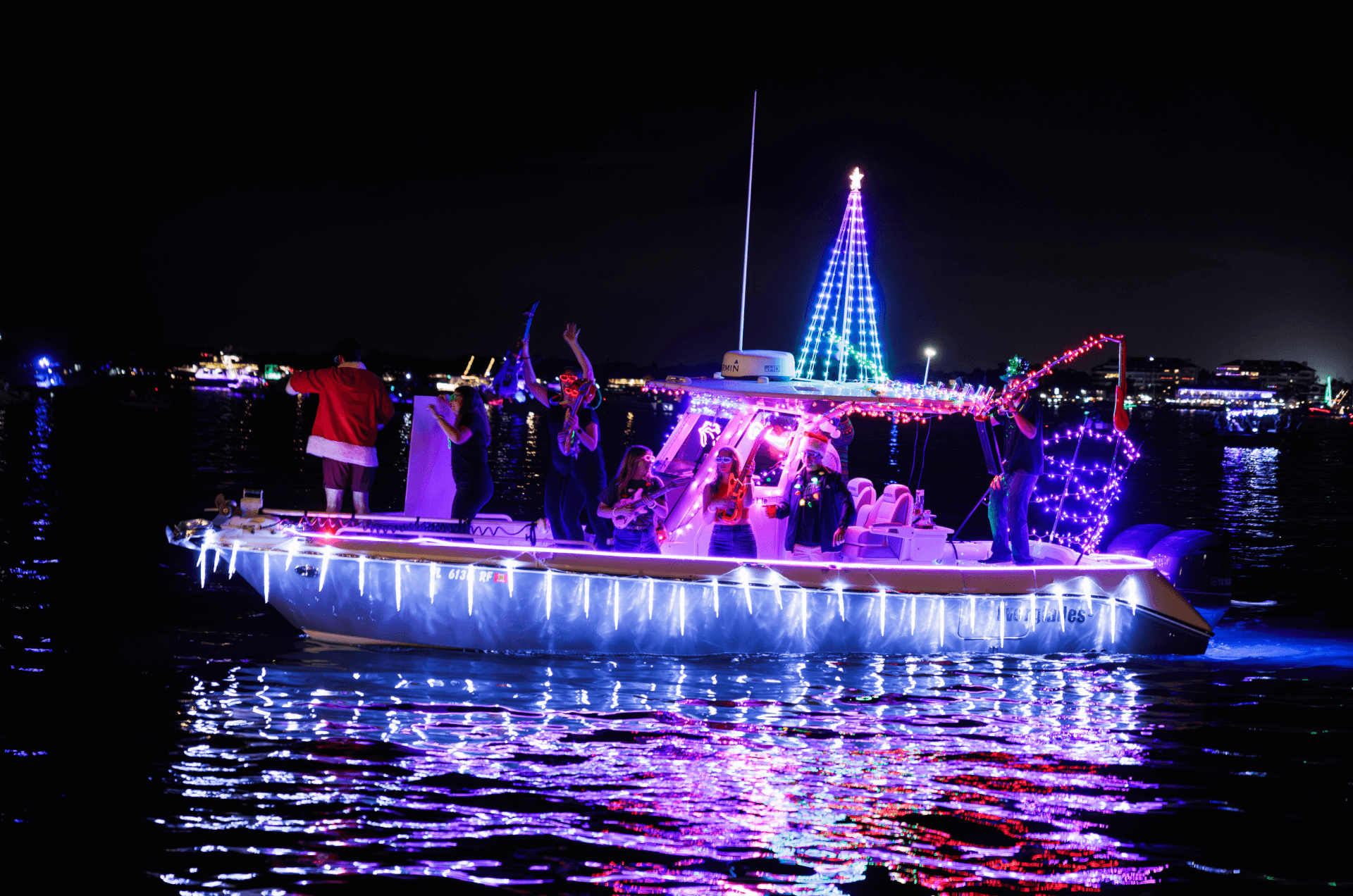 a group of people on a boat with lights